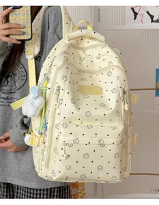 Detailed view of the cute cream school backpack featuring star and polka dot patterns.