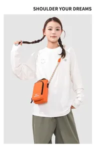Close-up of vibrant orange crossbody phone bag with colorful braided shoulder strap