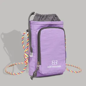 Purple nylon crossbody bag with drawstring closure and colorful rope strap for outdoor