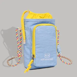 Light blue crossbody water bottle bag with yellow drawstring and colorful rope strap