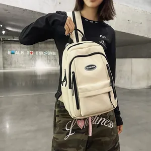 Minimalist cream white backpack for school and travel featuring multi-pocket design