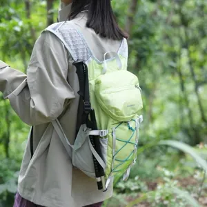 Lightweight light green outdoor hiking backpack with trekking poles in a forest setting