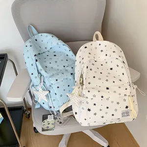 Star print student backpacks in light blue and cream colors for school and travel.