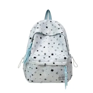 Stylish light blue school backpack featuring black star prints and decorative tassel detail