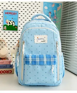 Front view of light blue star-patterned student backpack with plaid pocket detail