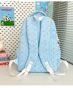 Back view of a light blue student backpack featuring cute star patterns and white straps