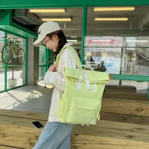Stylish lime green lightweight outdoor travel backpack shown on model in urban setting