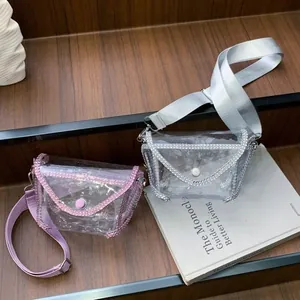 Stylish transparent PVC crossbody bag featuring sparkling rhinestone trim and wide strap