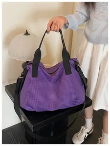 Detail of a large capacity purple grid nylon tote bag shown in a lifestyle setting