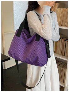 Detailed view of large purple checkered nylon tote bag worn by a model