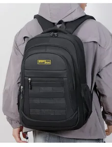 Back view of a large black outdoor travel backpack worn by a person in a gray jacket