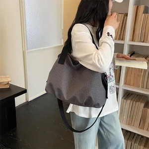 Large capacity plaid nylon tote bag for women commuting, shown in a library setting