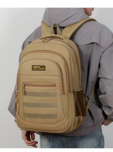 Large khaki tactical backpack for outdoor travel being worn by a man in a grey hoodie