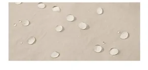 Close-up of waterproof beige nylon fabric with water droplets on surface