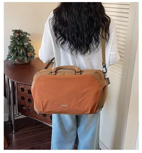 Back view of a stylish minimalist orange and brown travel bag carried by a model in a cozy room
