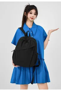 Minimalist black nylon backpack for women shown on a model for daily commute and school