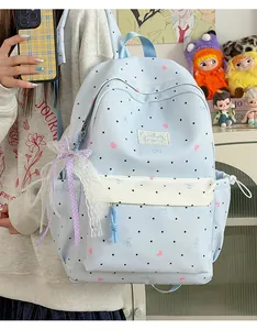 Cute blue Japanese school backpack with lace bow detail and polka dot pattern.