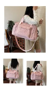 Close-up of pink corduroy duffel bag with multi-functional pockets and adjustable strap