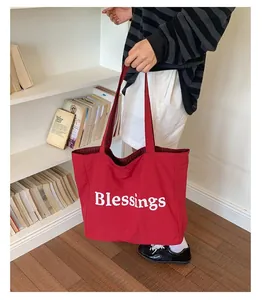 Large red nylon canvas tote bag with white Blessings print and checkered lining