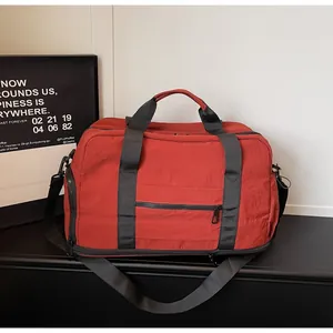 Durable large capacity red travel duffle bag with black straps for sports and fitness.