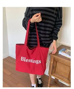 Casual red nylon tote bag with white Blessings print and plaid lining details
