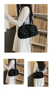 Black denim Boston bag with functional pockets shown from different angles on model