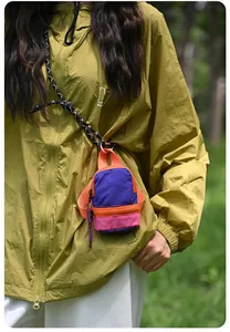 Detailed view of miniature colorful backpack pouch with zipper and stylish neck lanyard