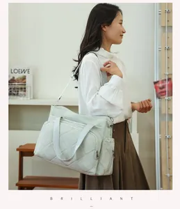 Large quilted diaper bag for mothers, stylish multi-functional travel tote bag.
