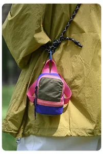 Vibrant mini backpack style storage pouch for earphones and lipstick with a black lanyard cord