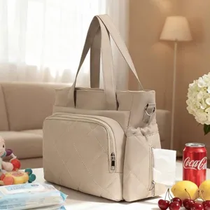 Beige quilted diaper bag with multifunctional pockets for travel and baby essentials