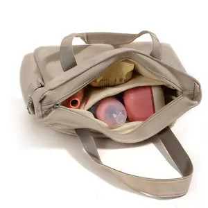 Beige quilted diaper bag with large capacity for travel and baby essentials