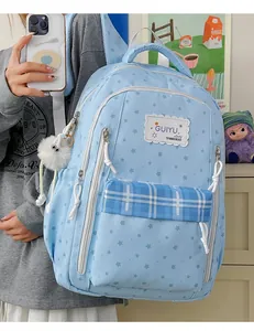 Blue star-patterned student backpack with plaid pocket detail and fluffy charm
