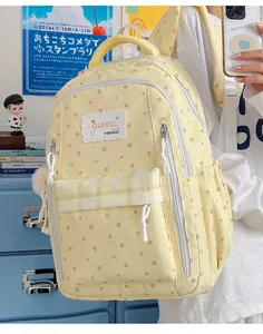 Close-up of yellow star-patterned fashion backpack for school girls in a cozy bedroom