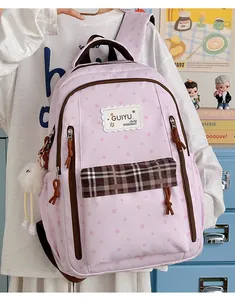 Pink student backpack with star patterns and checkered pocket detail