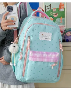 Close-up detail of a light blue star-patterned student backpack with GUIYU logo patch