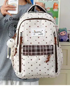 Cream student backpack featuring brown star patterns and a trendy plaid front pocket design
