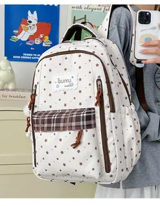 Close-up detail of a stylish student backpack with star patterns and a plaid front pocket