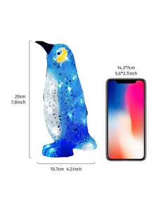 Detailansicht der blauen Pinguin-Gartenstecker mit Größenreferenz zum Handy.
