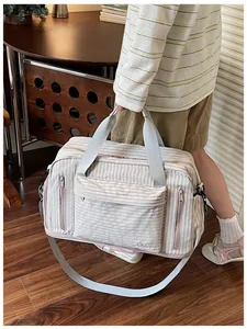 Detailed view of striped large travel bag with multiple zipper pockets