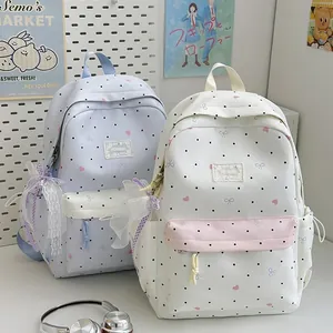 Cute Japanese style polka dot backpacks with lace bow charms for school students and travel