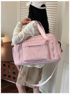Model carrying a large pink multi-functional travel bag for fitness and business trips