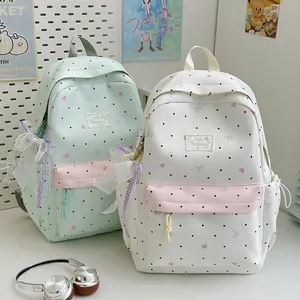 Two Japanese style cute backpacks with lace bows and polka dots for school girls