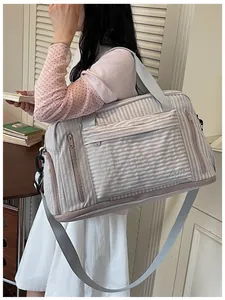 Asian model carrying a grey striped large capacity travel bag for gym or travel