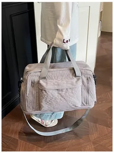Large capacity plaid travel bag held by person in a casual lifestyle setting