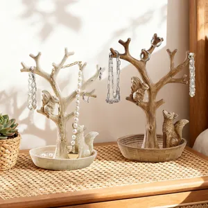 Schmuckständer aus Harz in Fuchs- und Baumform in Creme und Holzbraun auf einem Tisch