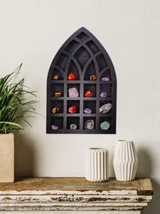Gothic arch wooden wall shelf displaying colorful polished crystals in a rustic room