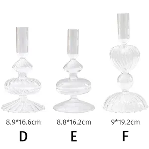 Detailed view of three unique transparent glass candle holders labeled D, E, and F with sizes