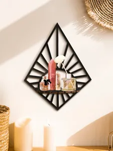 Minimalist black diamond-shaped wooden wall shelf displaying crystals and aromatherapy bottles