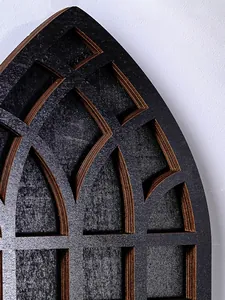 Detailed macro view of a gothic arched wooden wall shelf showing textured black grain and ply edges