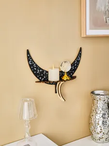 Wall-mounted wooden moon shelf featuring intricate star patterns and a decorative candle